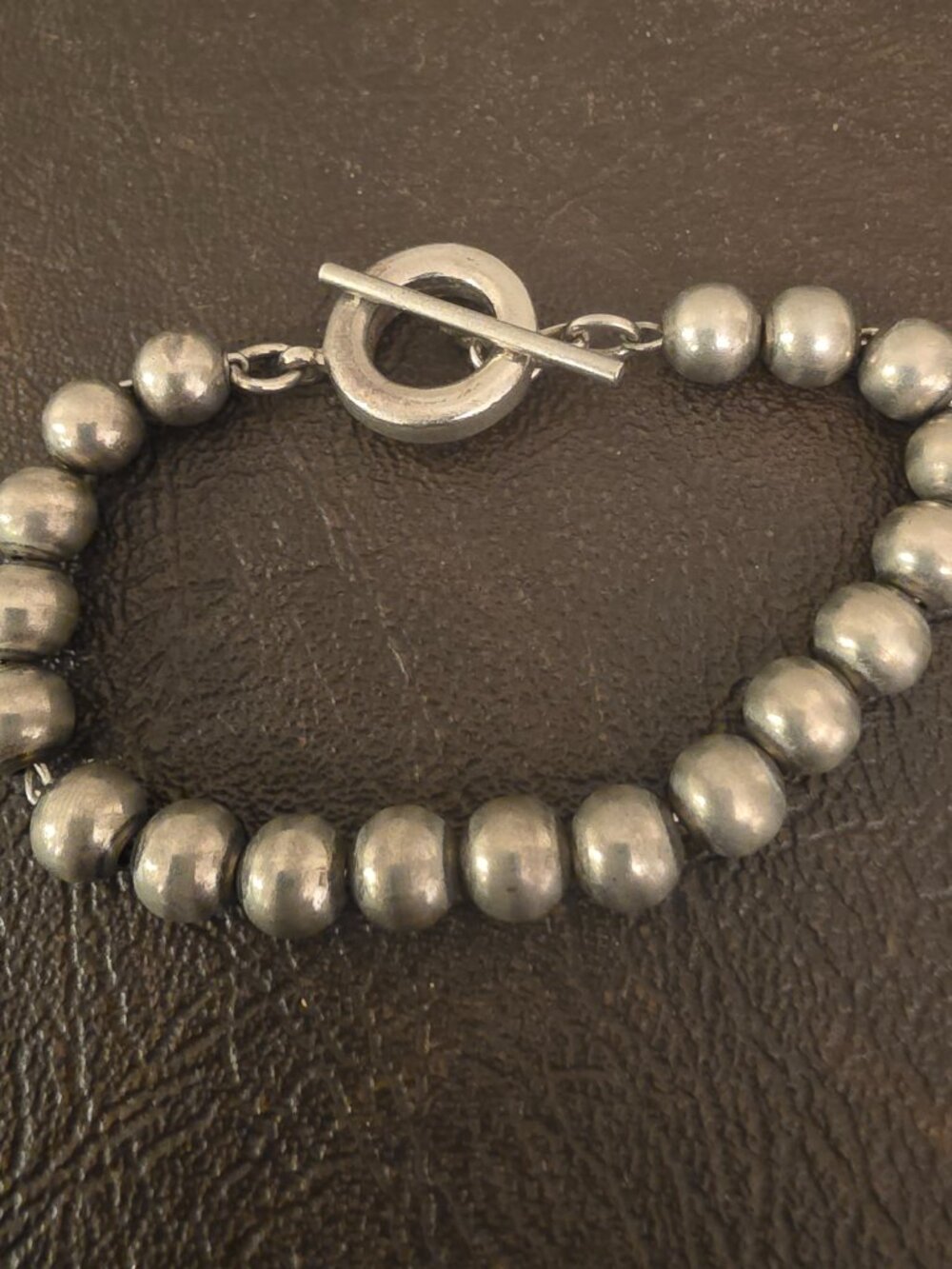 sterling silver bracelet features round bead balls with a toggle clasp closure
